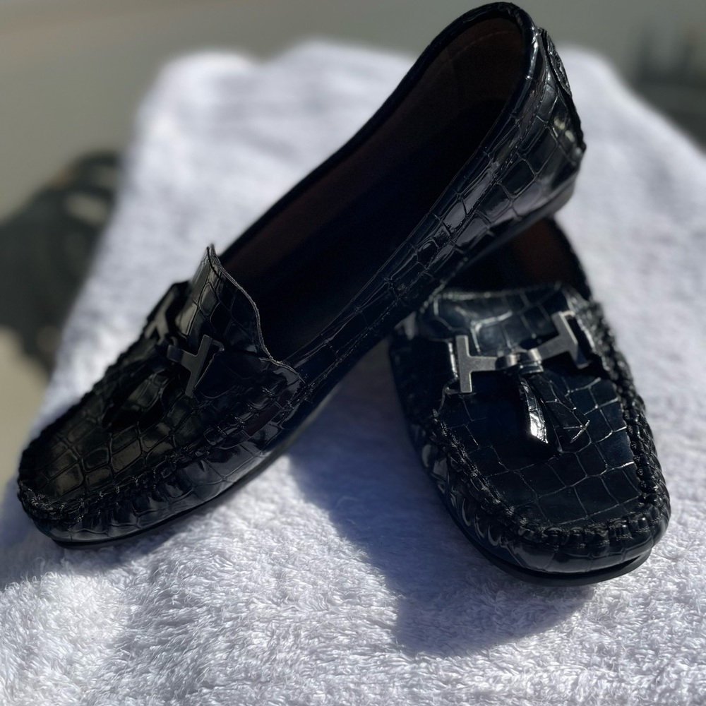 Black shiny print. Size 7 saint johns bay brand loafers.
